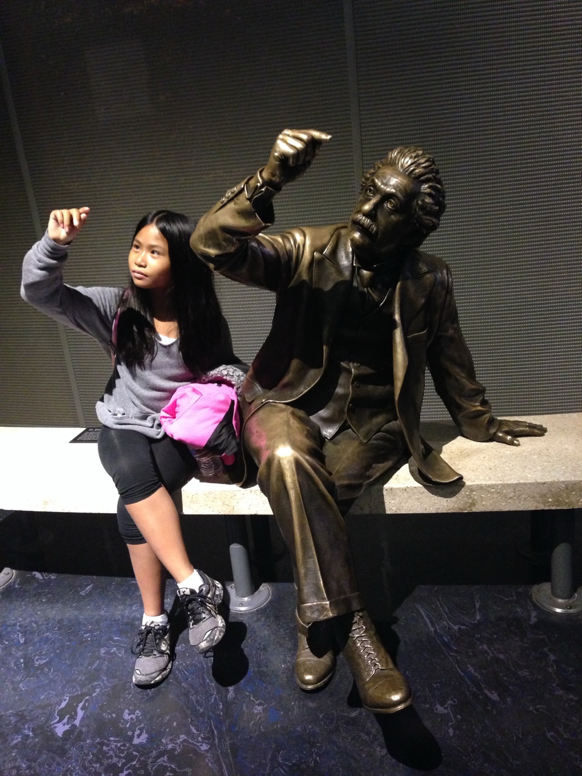 Geordie beside a statue at Griffith Observatory.